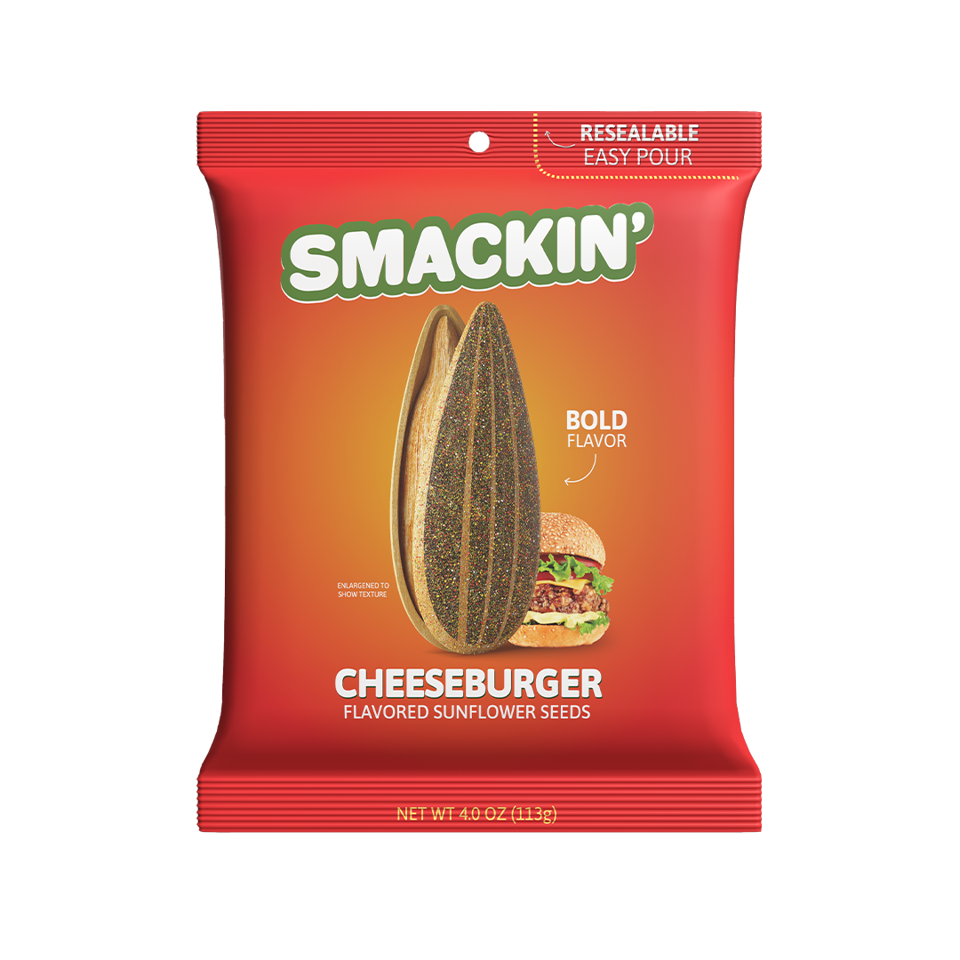 Product photo of a red Smakin' Cheeseburger Flavored Sunflower Seeds bag featuring a green "SMACKIN'" logo, a large split sunflower seed displaying textured seeds, a small cheeseburger graphic, and a "RESEALABLE EASY POUR" top