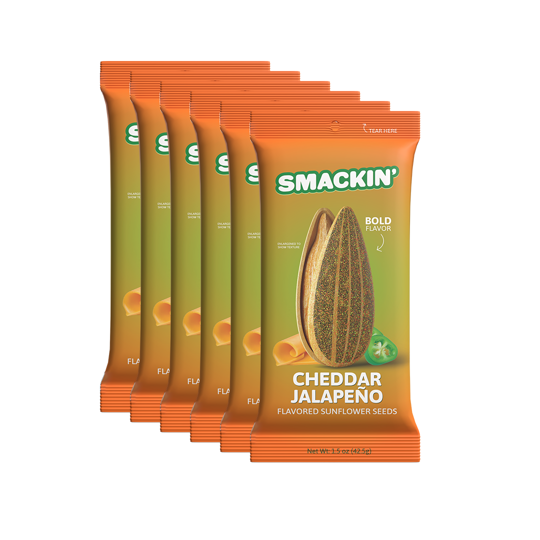 Six vibrant orange and olive-green Smackin' Cheddar Jalapeño flavored sunflower seed snack packages featuring a large illustrative seed, cheese curls, and a green jalapeño slice with bold flavor text on a white background