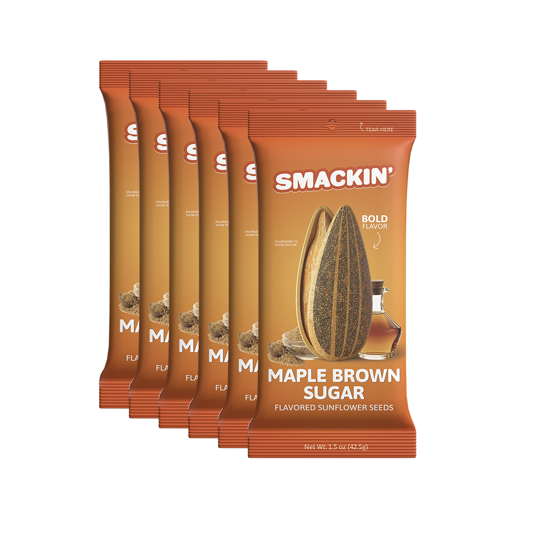 A stack of six Smackin' Maple Brown Sugar flavored sunflower seeds pouches, featuring vibrant orange and brown packaging with a large sunflower seed and a small maple syrup bottle on the front, highlighting "Bold Flavor"