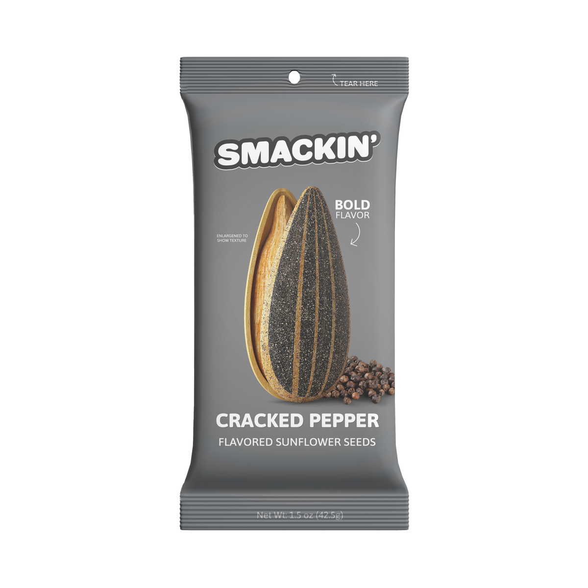 Product photography of a gray Smackin' Cracked Pepper Flavored Sunflower Seeds pouch featuring an enlarged cracked sunflower seed revealing a vibrant yellow interior and a black speckled shell, accompanied by a small pile of whole black peppercorns