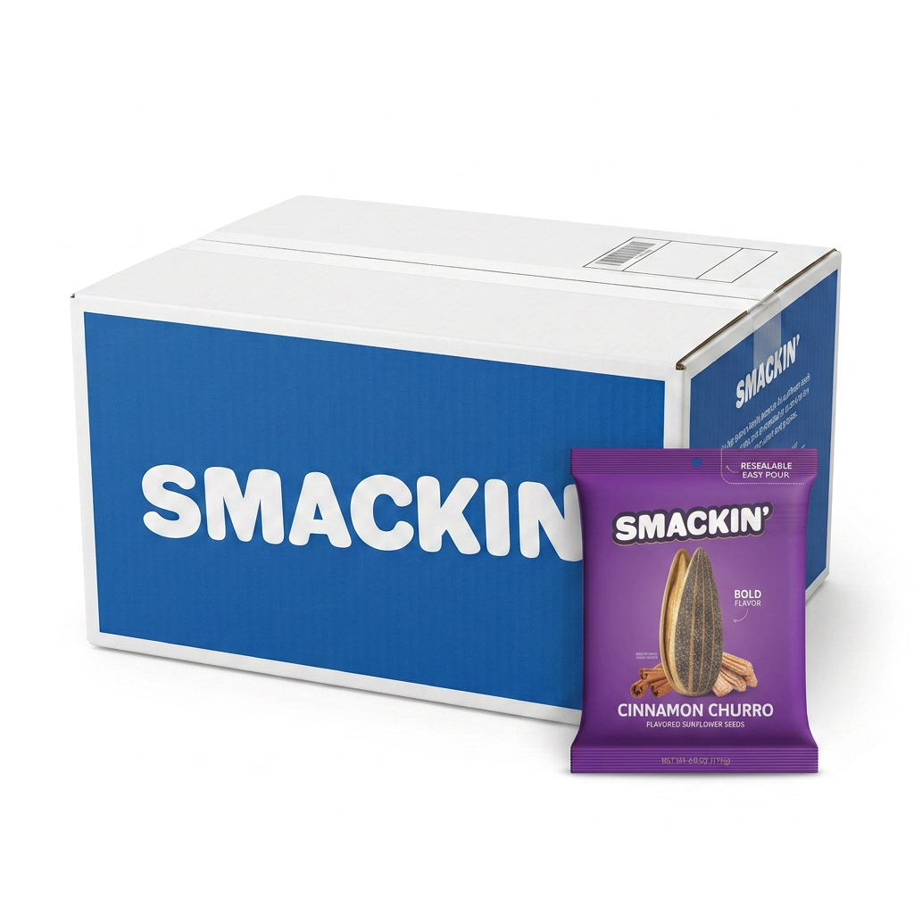 Product photo of a large white cardboard box with a blue SMACKIN logo and a small purple foil pouch of SMACKIN Cinnamon Churro flavored sunflower seeds featuring an open sunflower seed and cinnamon sticks on a clean white studio background