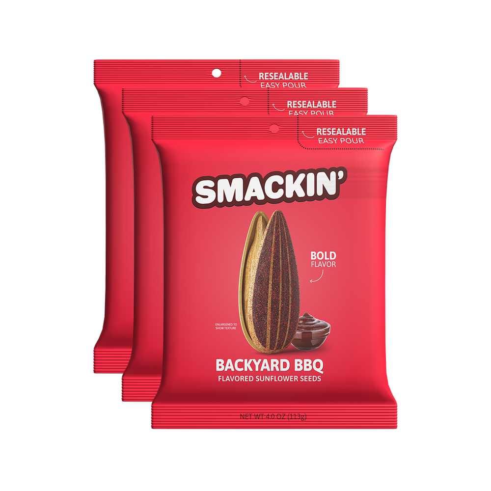 Digital product photography of three bright red Smackin' Backyard BBQ flavored sunflower seed bags on a white background featuring a large striped sunflower seed and a bowl of BBQ sauce with Resealable Easy Pour tops