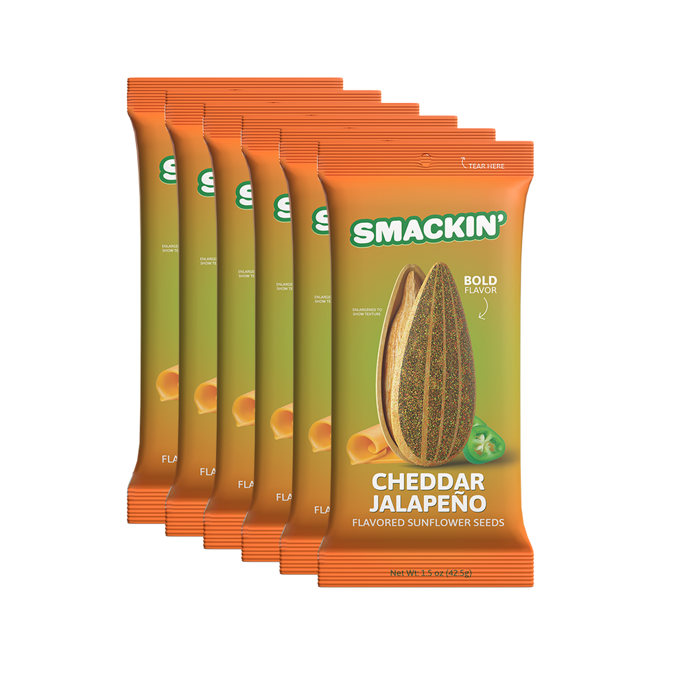 Six vibrant orange and olive-green Smackin' Cheddar Jalapeño flavored sunflower seed snack packages featuring a large illustrative seed, cheese curls, and a green jalapeño slice with bold flavor text on a white background