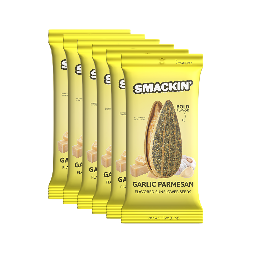 Product photography of six bright yellow Smackin' Garlic Parmesan Flavored Sunflower Seeds packets on a white background, featuring an enlarged sunflower seed, parmesan cheese cubes, and garlic cloves with a 'Bold Flavor' indicator