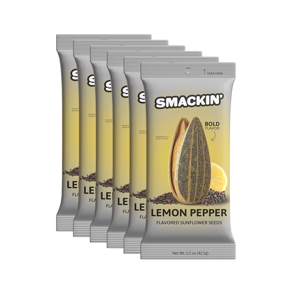 Product photography of six Smackin' Lemon Pepper Flavored Sunflower Seeds snack pouches isolated on a white background, each gray and yellow pouch displaying an enlarged striped sunflower seed, a vibrant lemon slice, and black peppercorns, highlighting the "Bold Flavor" and "Tear Here" opening