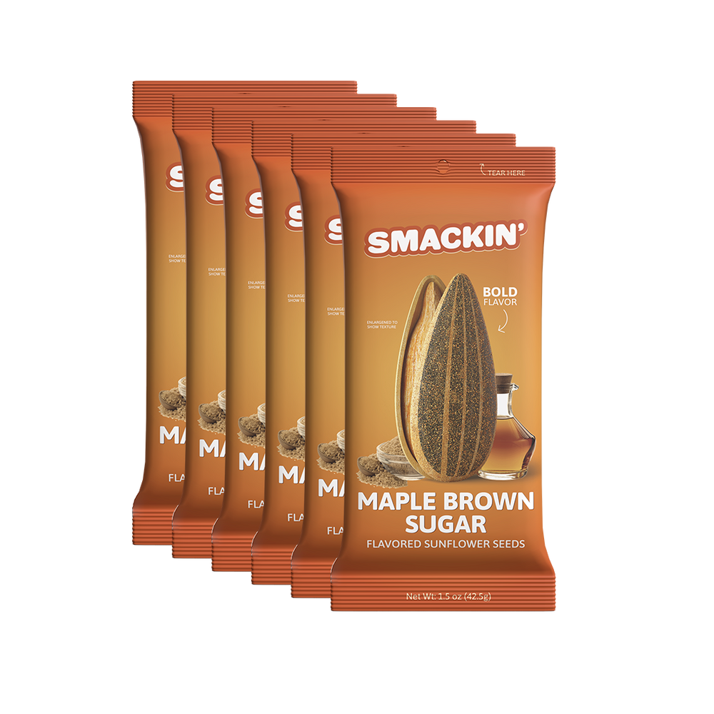A stack of six Smackin' Maple Brown Sugar flavored sunflower seeds pouches, featuring vibrant orange and brown packaging with a large sunflower seed and a small maple syrup bottle on the front, highlighting "Bold Flavor"