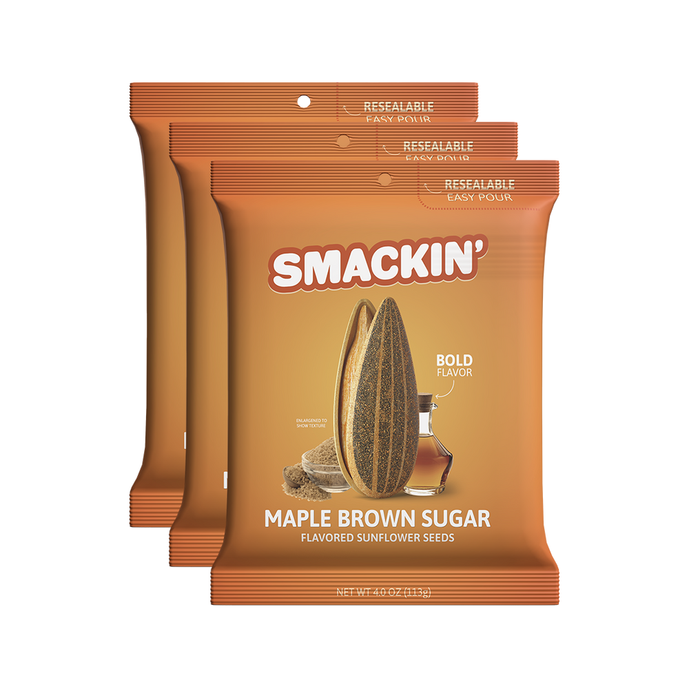 Product photography of three orange Smackin' Maple Brown Sugar Flavored Sunflower Seeds bags featuring a resealable easy-pour top, a large sunflower seed graphic, and depictions of maple syrup with brown sugar