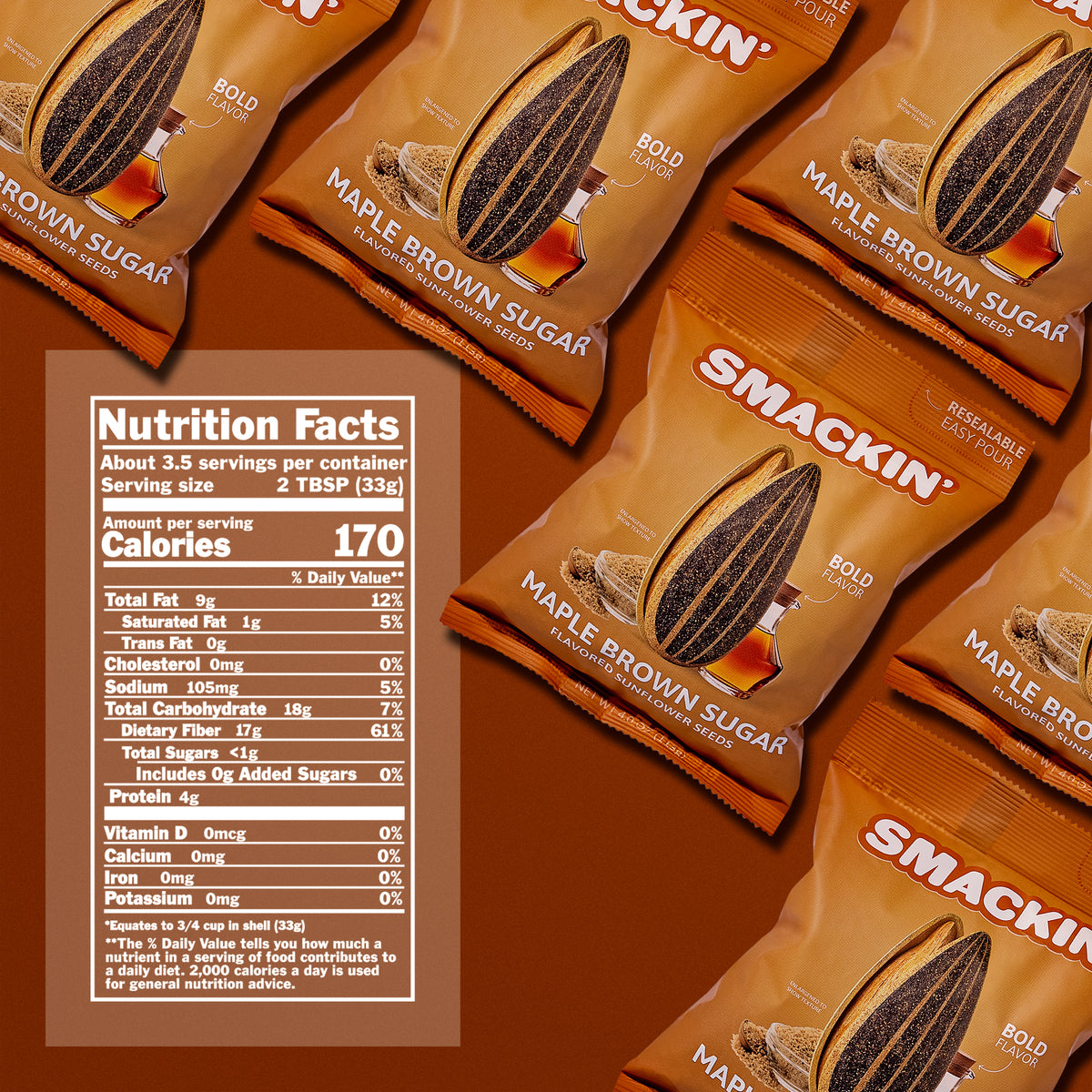 Product photography of multiple Smackin' Maple Brown Sugar Flavored Sunflower Seeds bags on a warm brown surface, showcasing their distinctive brown and orange packaging with an illustrated sunflower seed, maple syrup, and brown sugar, alongside a visible nutrition facts label highlighting 170 calories